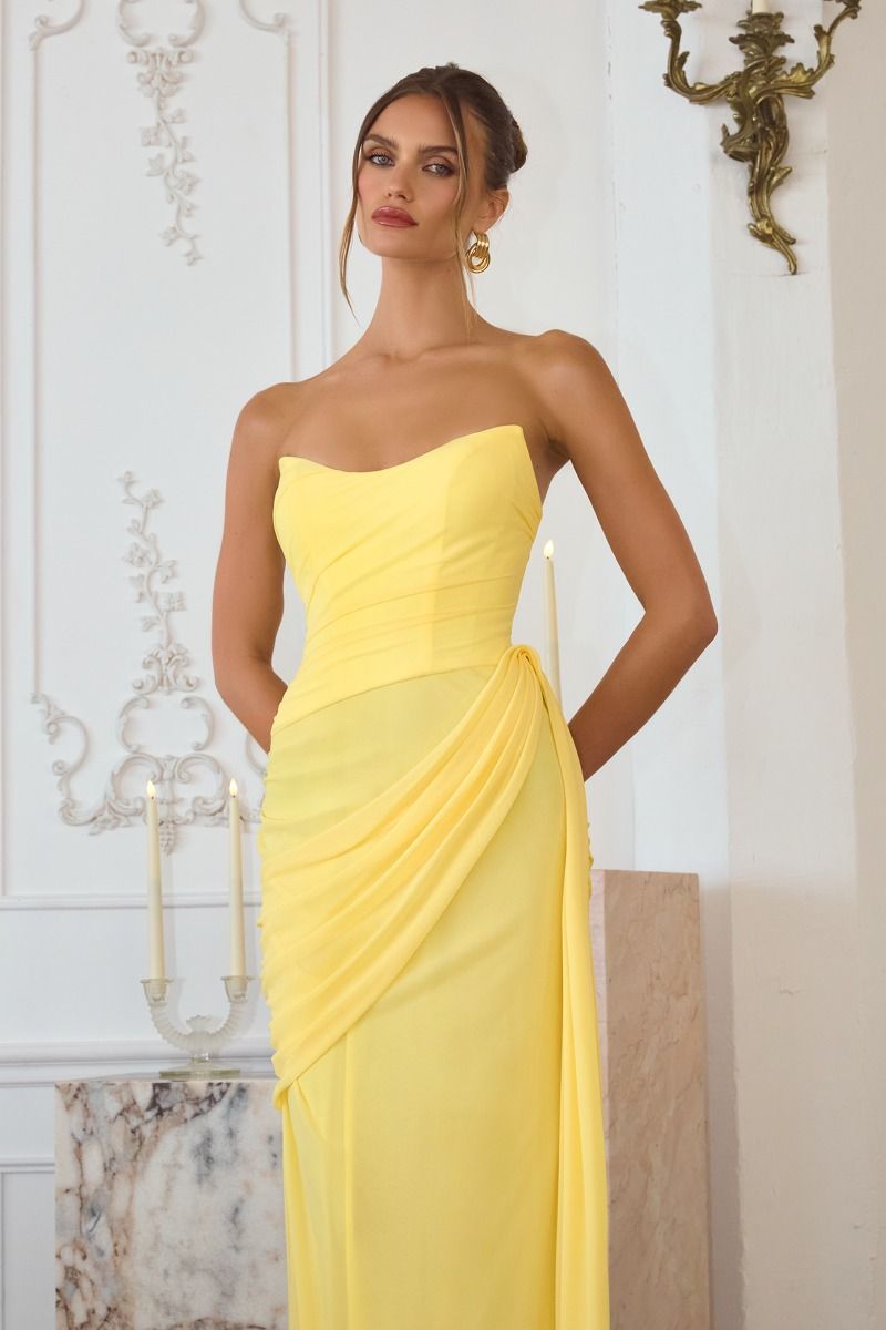 chiffon gown, designed with a sleek strapless neckline and soft, body-sculpting draping