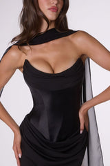 Woman wearing a black dress with a white background