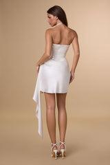 Woman wearing a white dress with a beige background