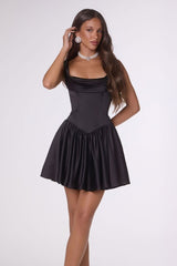 Woman wearing a black dress on a white background