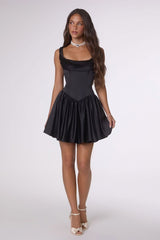 Woman wearing a black dress on a white background