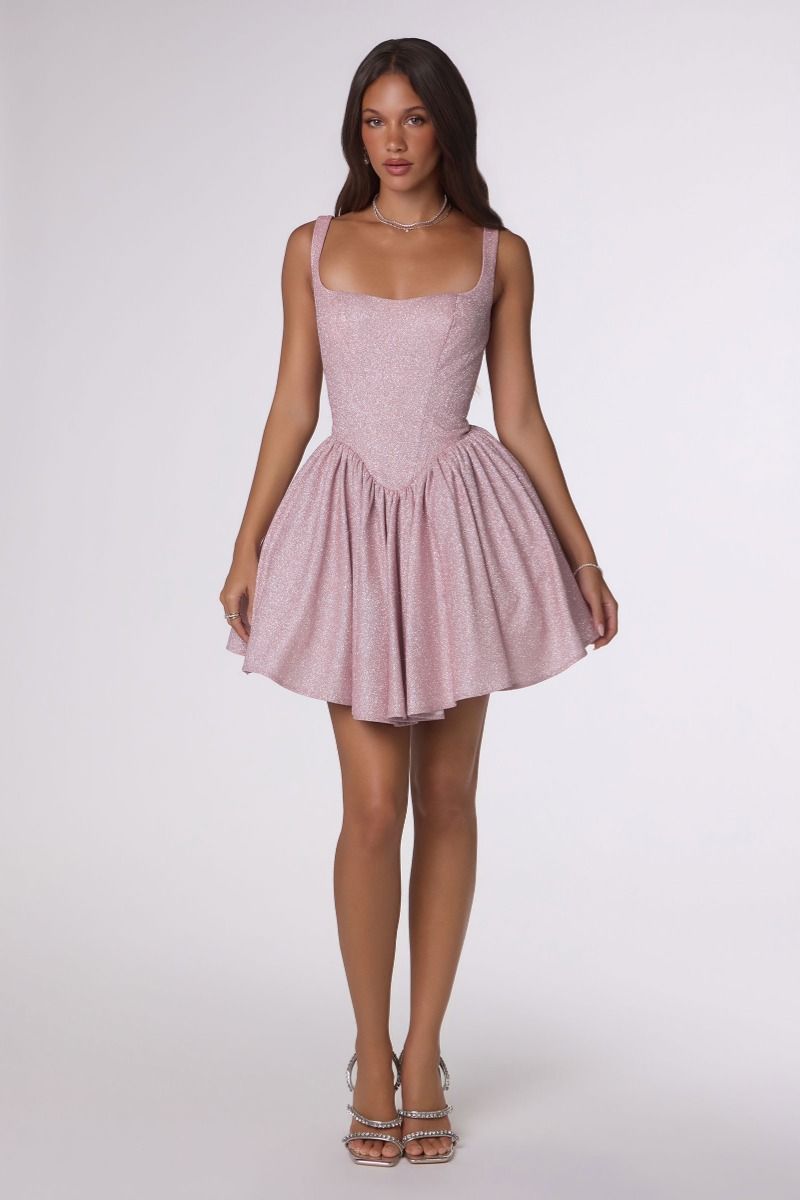 Woman wearing a pink dress on a white background
