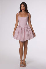 Woman wearing a pink dress on a white background
