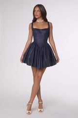 Woman wearing a navy blue dress on a white background