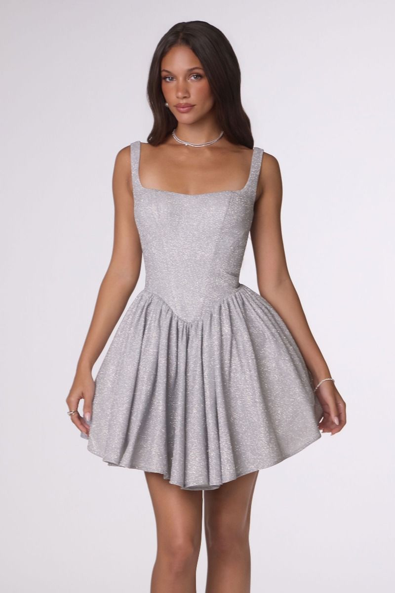 Woman wearing a gray dress on a white background