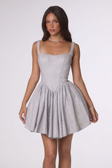 Woman wearing a gray dress on a white background