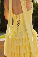 Yellow dress with ruffled layers and lace back detail.