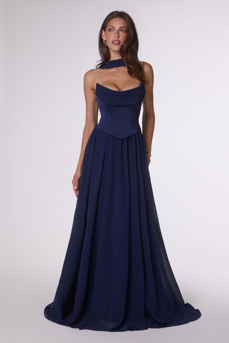 Woman wearing a navy blue evening gown on a white background
