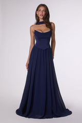 Woman wearing a navy blue evening gown on a white background