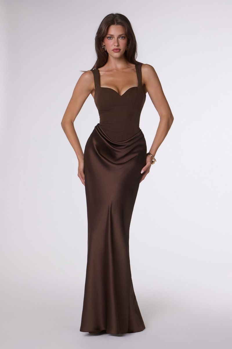 Woman wearing a brown evening gown on a white background