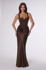 Woman wearing a brown evening gown on a white background
