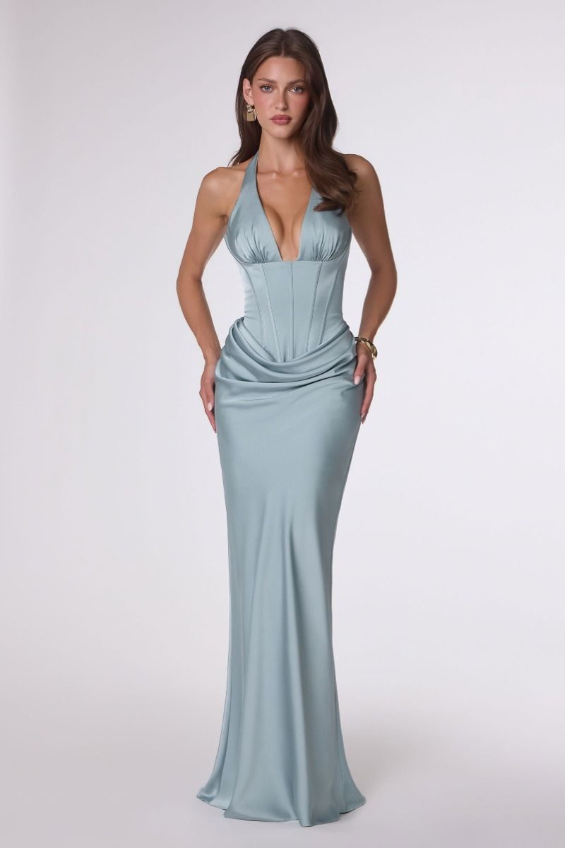 Woman wearing a light blue evening gown on a white background