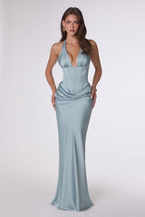 Woman wearing a light blue evening gown on a white background