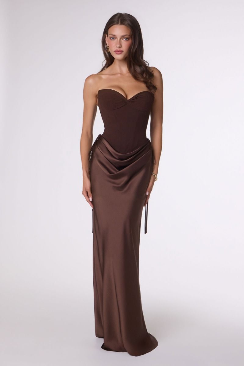 Woman wearing a brown strapless gown on a white background