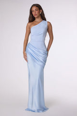 Woman wearing a light blue one-shoulder evening gown on a white background