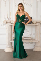 Woman wearing a green evening gown in an elegant interior setting