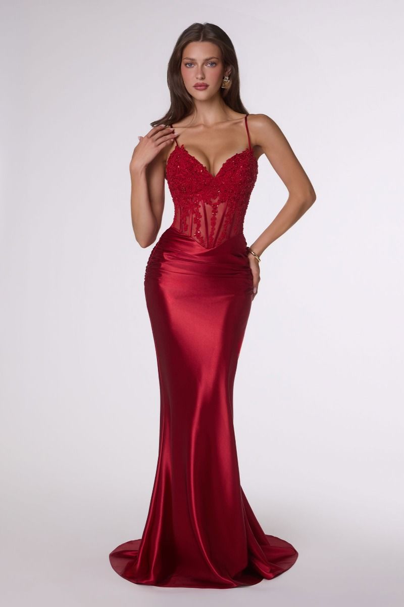 Red evening gown on a model against a white background