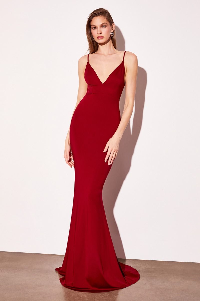 Red evening gown on a model against a white background