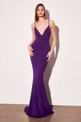Woman wearing a purple evening gown against a white background