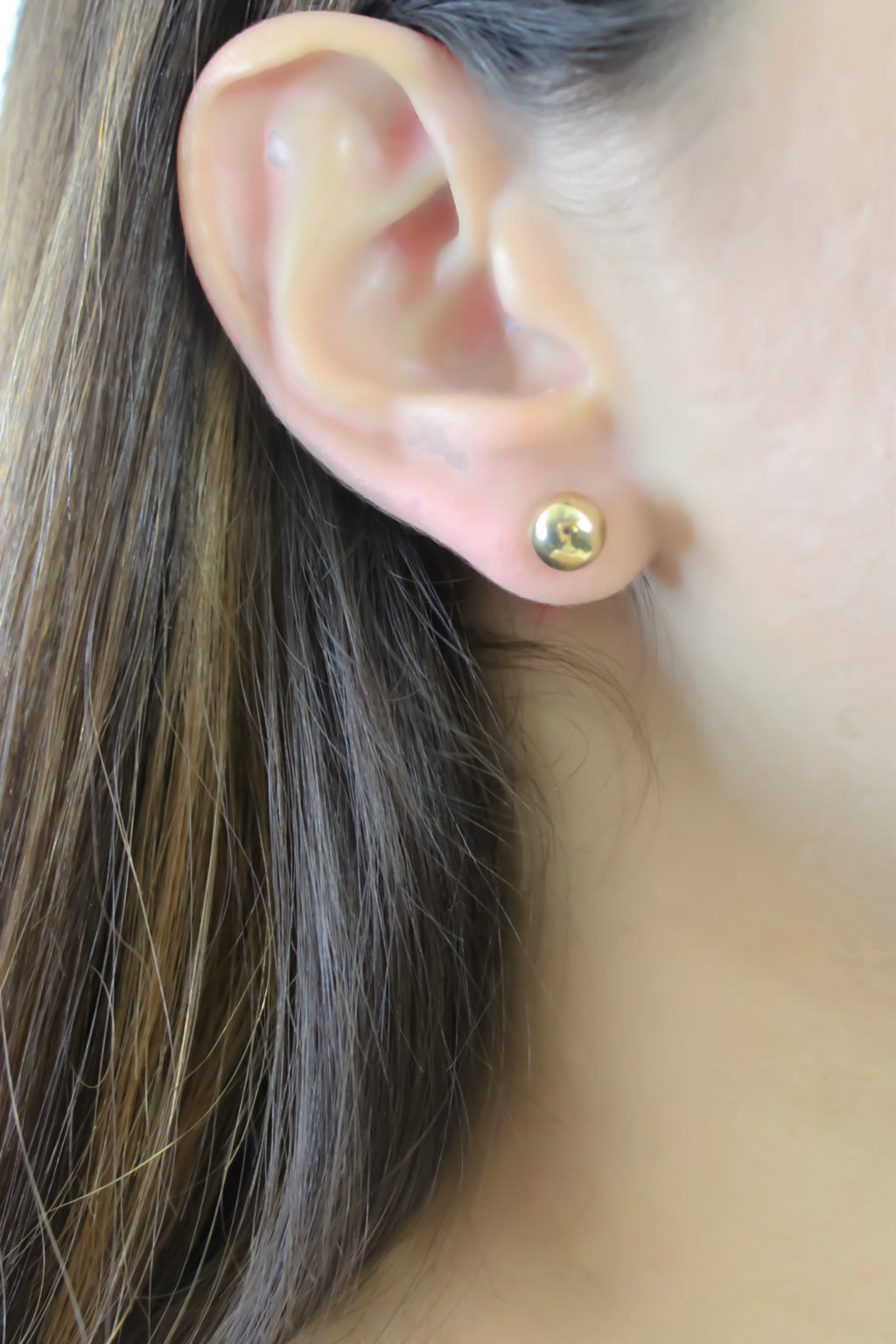 Gold studded earrings.
