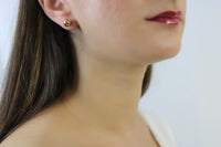 Gold studded earrings.