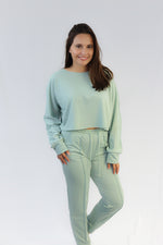 Green cropped sweater with matching joggers.