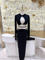 Long sleeve crop top with cutout in black.