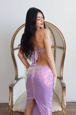 Lavender Sequins top that is adjustable by the tie around the back and neck. Paired with a matching low waisted sequin midi skirt.