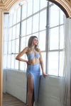 Midi skirt with a ruched slit and matching bra top in blue.