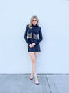 Black crop long sleeve top with shoulder pads and rhinestone breast outline.