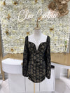 Black and gold tight dress with puff long sleeves.