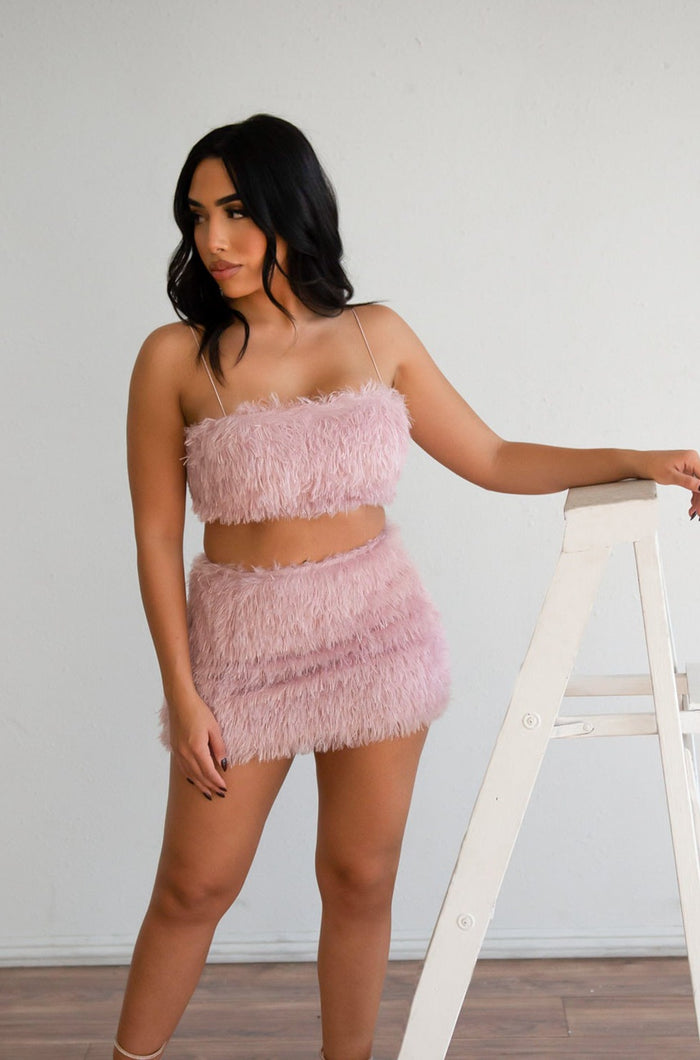 Pink colored furry crop top paired with tight furry mini skirt.