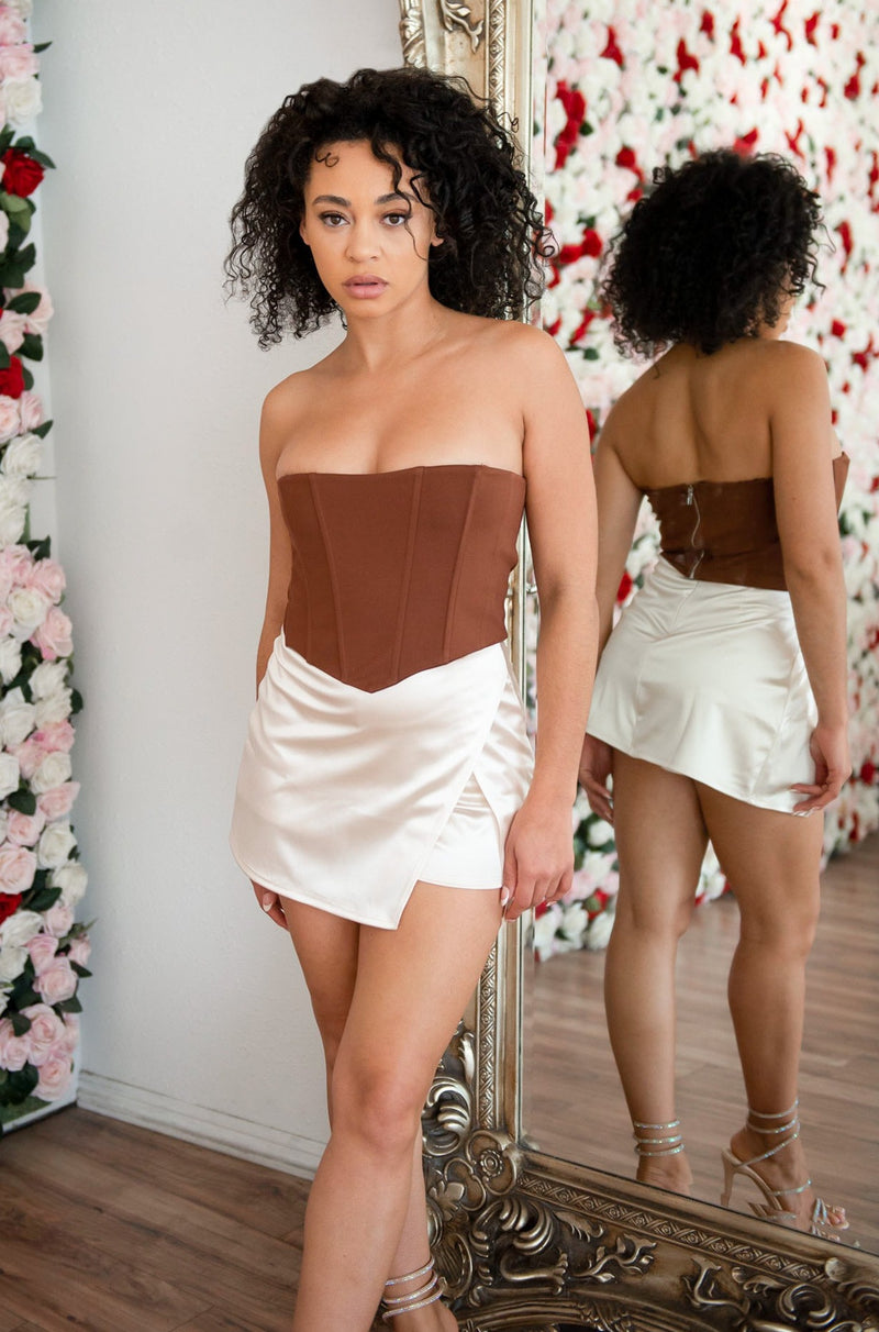 Cream mini satin skirt with attached shorts underneath. 