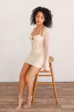 Long mesh sleeve corset style mini dress with halter neck in Cream.