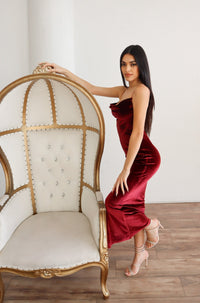 Wine red velvet midi dress with a low back and tight fit.