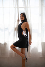 Black slip dress with a halter neck scarf, low back and straps to connect the dress in the back.