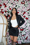 Cropped leather blazer paired with matching mini skirt in Black.