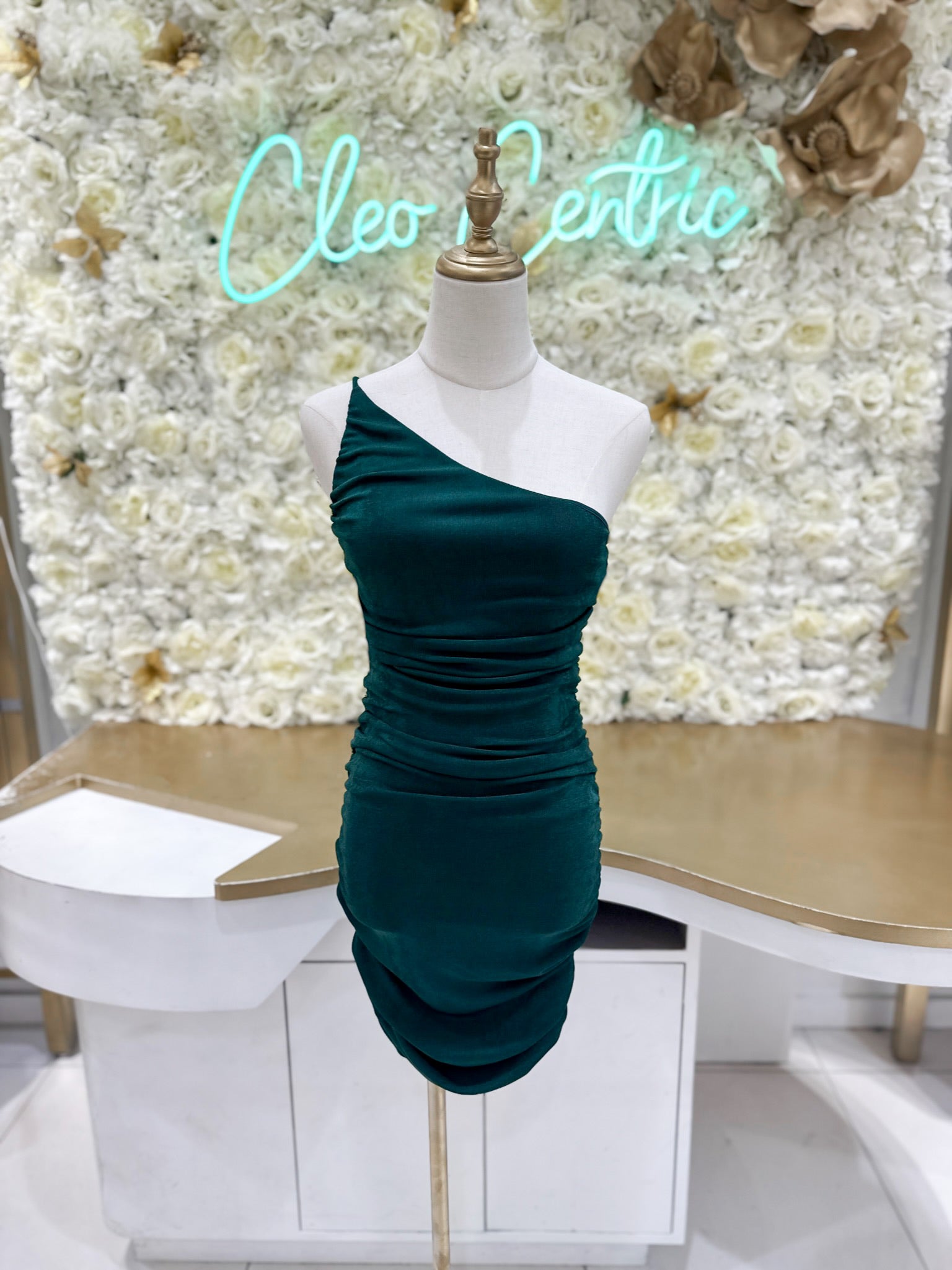 Green ruched one shoulder dress.