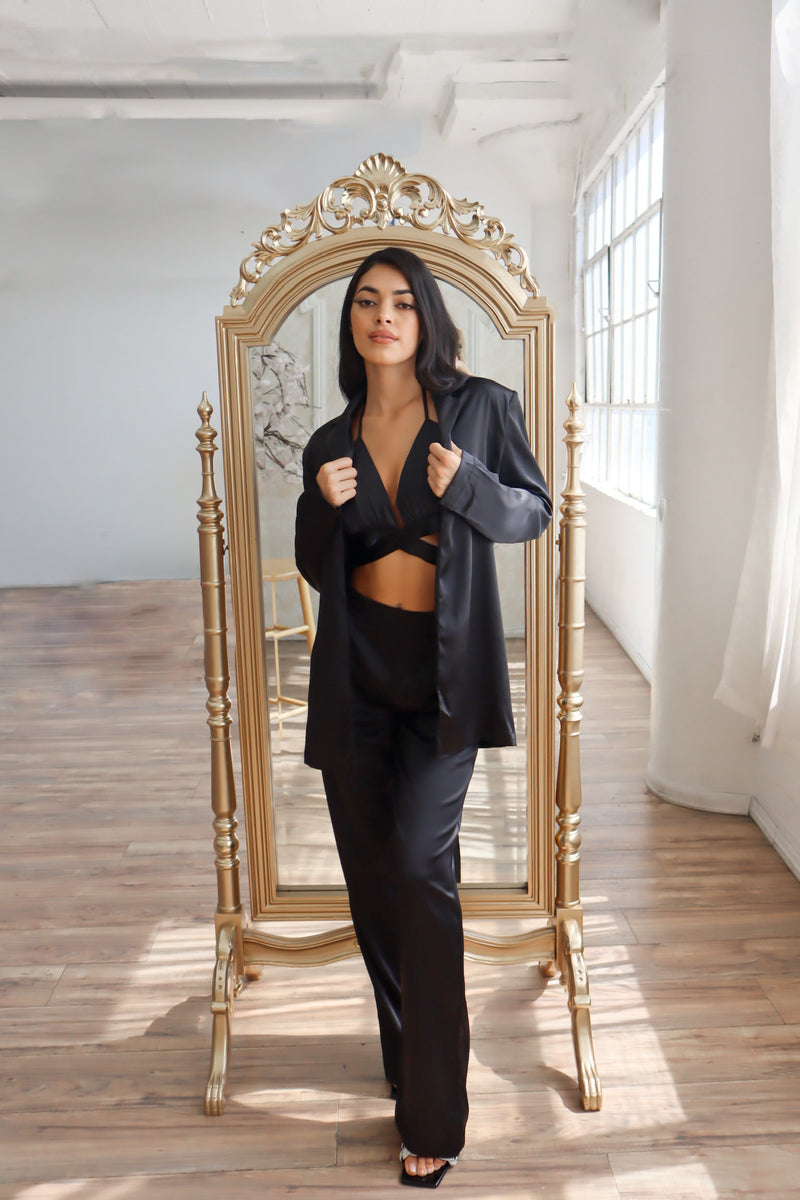 Satin blazer paired with satin bra top and satin pants in black.