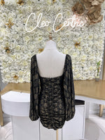 Black and gold tight dress with puff long sleeves.