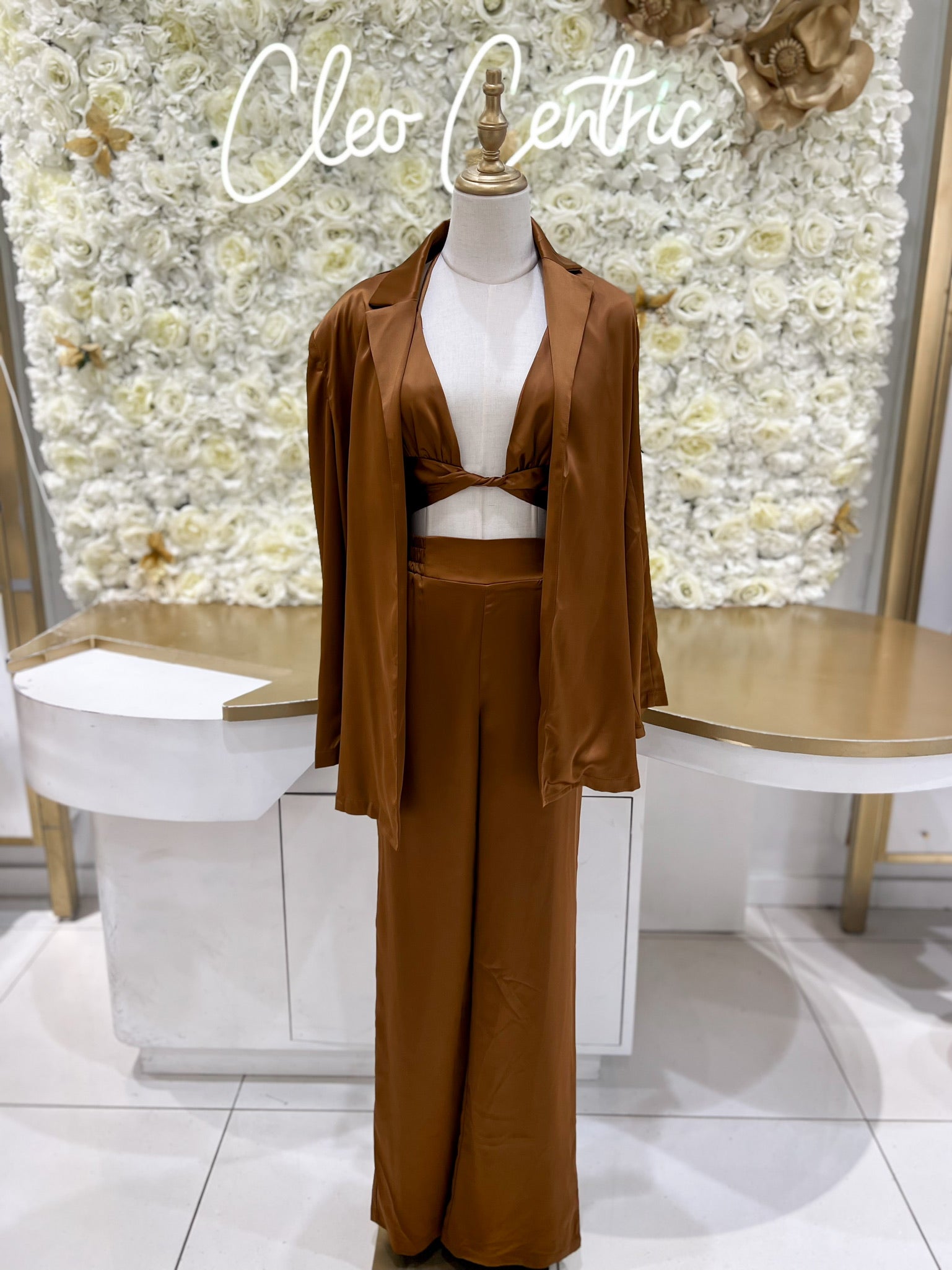 Satin blazer paired with satin bra top and satin pants in brown.