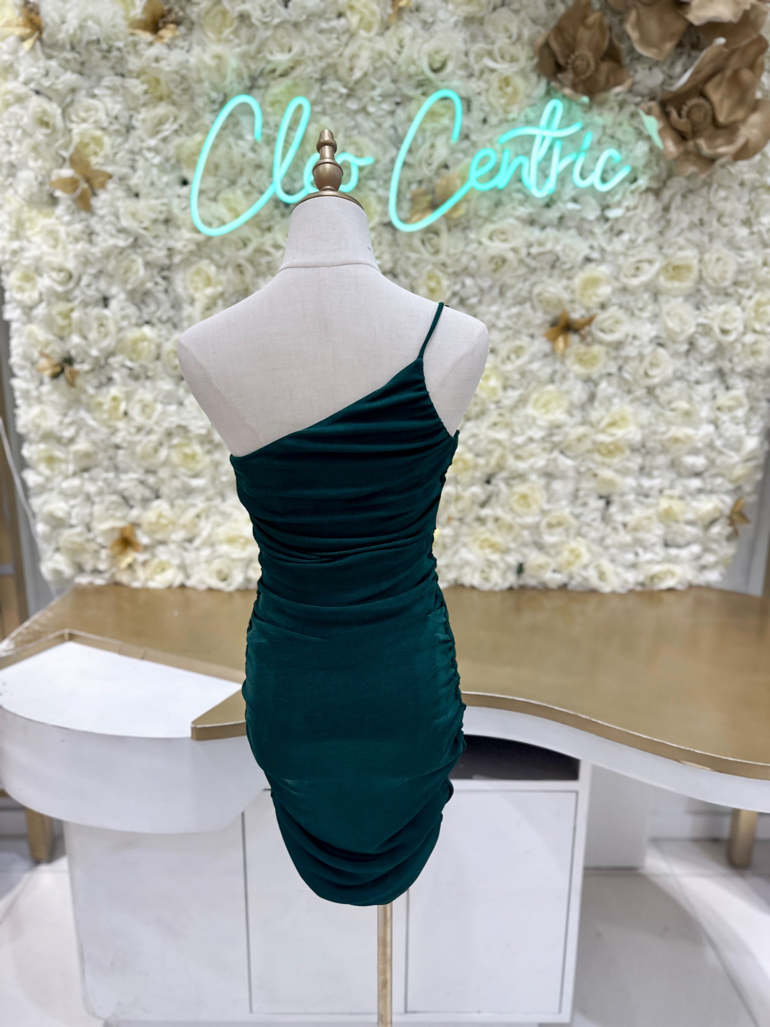 Green ruched one shoulder dress.