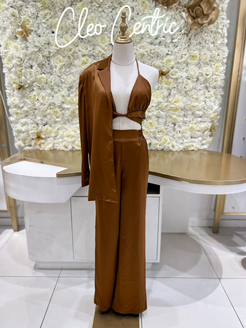 Satin high waisted pants paired with a matching satin bra top and blazer in brown.