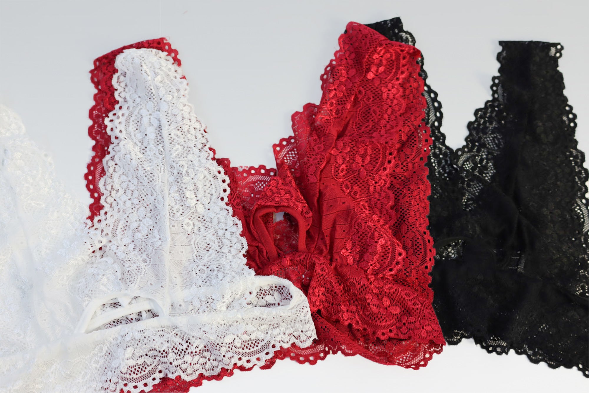 Lace bralette in white, red, and black.